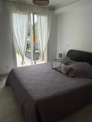 a bedroom with a bed and a large window at Appartement en bas de villa in Ocana