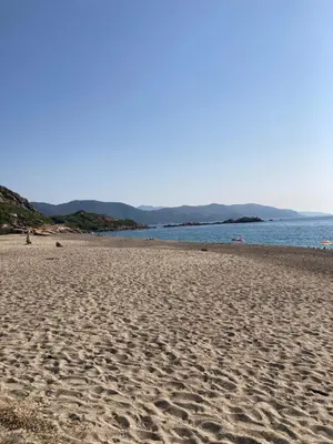 a sandy beach with the ocean in the background at Golfe de Sagone Plage du Liamone Maison pieds dans l'eau in Casaglione