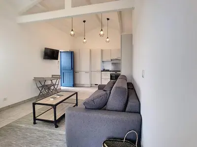 a living room with a couch and a table at Golfe de Sagone Plage du Liamone Maison pieds dans l'eau in Casaglione