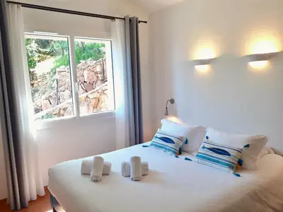 a bedroom with a bed with two towels on it at Résidence Belvedere de Palombaggia in Porto-Vecchio