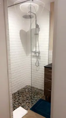 a shower with a glass door in a bathroom at Bel appartement dans Villa avec piscine en Corse du Sud in Grossa