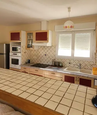 a kitchen with a sink and a stove top oven at Villa à Pinarello-2mn à pied de la plage-vue mer in Pinarellu