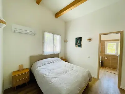a bedroom with a white bed and a window at Maison d’hôtes Joséphine in Ajaccio