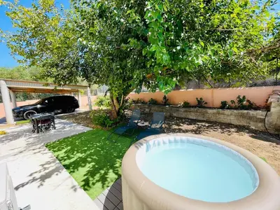 a hot tub in a yard with a tree at Maison d’hôtes Joséphine in Ajaccio