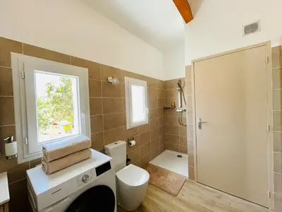 a bathroom with a toilet and a window at Maison d’hôtes Joséphine in Ajaccio