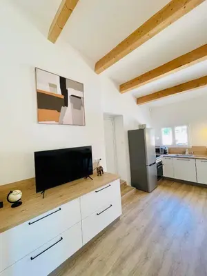 a living room with a flat screen tv on a counter at Maison d’hôtes Joséphine in Ajaccio