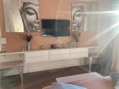 a living room with a tv on the wall at Villa Santoni 2 in Grosseto-Prugna