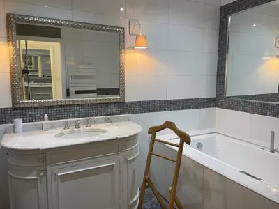 a bathroom with a sink and a tub and a mirror at Villa Santoni 2 in Grosseto-Prugna
