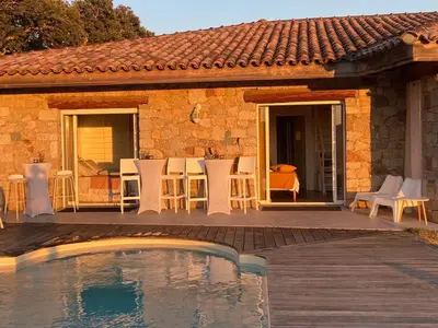 a house with a swimming pool in front of a house at Villa Santoni 2 in Grosseto-Prugna