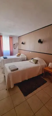 a hotel room with two beds in a room at A CASA DI ROSA in Serra-di-Ferro