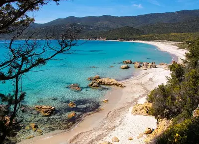 a view of a beach with blue water and rocks at A CASA DI ROSA in Serra-di-Ferro