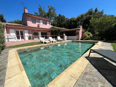 a swimming pool in front of a house at Villa de charme à Marina di fiori in Porto-Vecchio