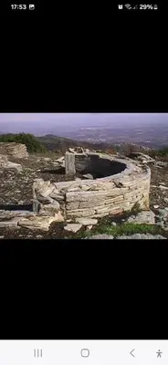 a picture of a stone building on top of a hill at Le Refuge de la Tour entre mer et ciel in Porri