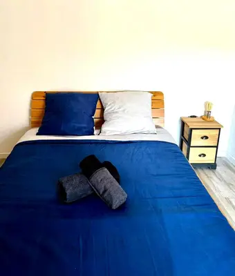 a bed with blue sheets and blue pillows at A Torra entre mer et ciel in Porri