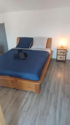 a bedroom with a bed with a blue blanket on it at A Torra entre mer et ciel in Porri