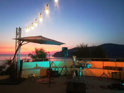 a stage with lights in front of a sunset at Village de vacances Paese di Lava, Grand Ajaccio in Alata