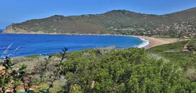 a view of a beach with mountains in the background at Village de vacances Paese di Lava, Grand Ajaccio in Alata