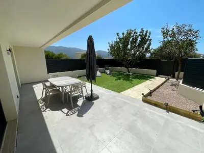 a patio with a table and an umbrella at Casa Di Lucianu in Casaglione