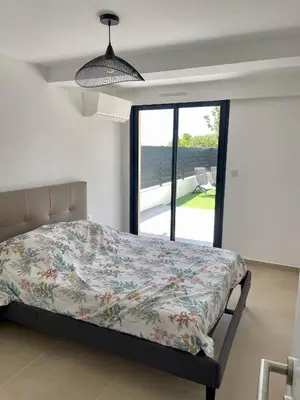 a bedroom with a bed and a large window at Casa Di Lucianu in Casaglione