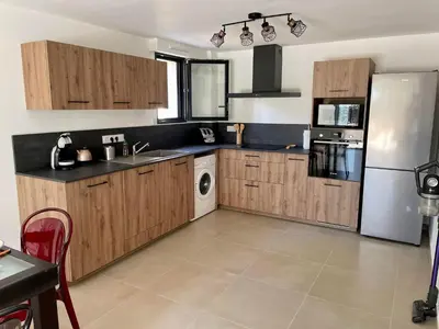 a kitchen with wooden cabinets and a white refrigerator at Casa Di Lucianu in Casaglione