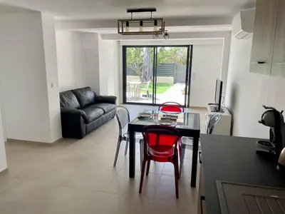 a kitchen and living room with a table and chairs at Casa Di Lucianu in Casaglione