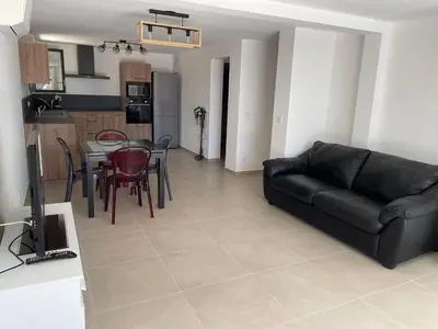 a living room with a black couch and a table at Casa Di Lucianu in Casaglione