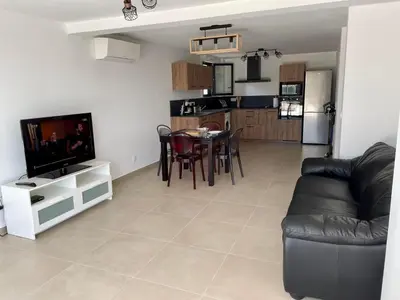a living room with a couch and a tv and a table at Casa Di Lucianu in Casaglione