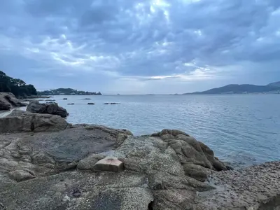 a large body of water with rocks on the shore at Propriano Chalet near Sandy Beaches in Propriano