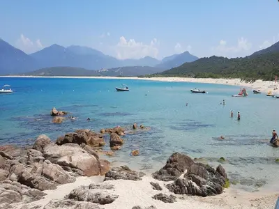 a group of people in the water at a beach at Propriano Chalet near Sandy Beaches in Propriano