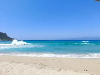 a sandy beach with waves in the ocean at Propriano Chalet near Sandy Beaches in Propriano