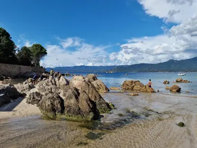 a group of people on a beach with rocks at Propriano Chalet near Sandy Beaches in Propriano