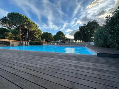 a bedroom with a bed and a mirror and a chair at T4 neuf Porto Vecchio Calarossa in Lecci