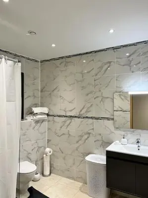 a bathroom with a shower and a sink and a toilet at Maison centre-ville in Penta-di-Casinca