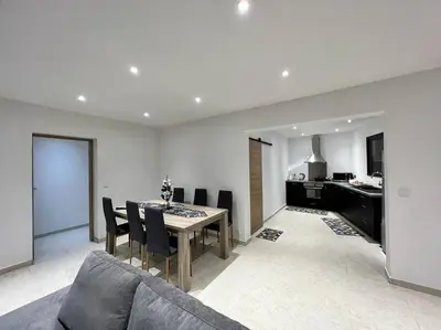 a kitchen and dining room with a table and chairs at Maison centre-ville in Penta-di-Casinca