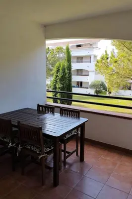 a table and chairs in a room with a large window at Casa Emma les pieds dans l'eau in San-Nicolao