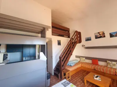 a living room with a staircase and a couch at TB Porticcio vue mer in Grosseto-Prugna