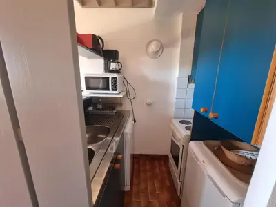 a small kitchen with a sink and a microwave at TB Porticcio vue mer in Grosseto-Prugna