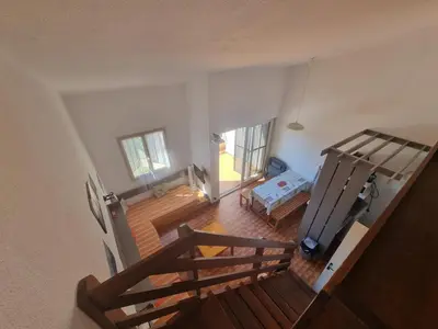 an overhead view of a room with a staircase and a bedroom at TB Porticcio vue mer in Grosseto-Prugna