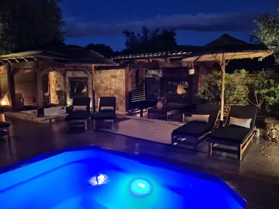 a pool in front of a house at night at Chambre d'hôte Casa Maredda in Porticcio