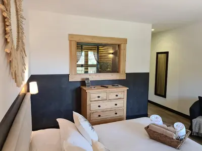 a bedroom with a bed and a dresser with a mirror at Chambre d'hôte Casa Maredda in Porticcio