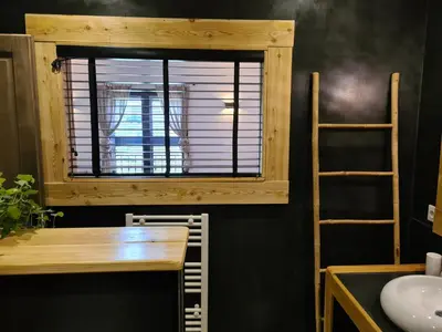 a bathroom with a table and a window with a sink at Chambre d'hôte Casa Maredda in Porticcio