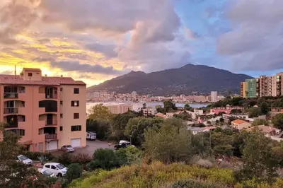 a view of a city with a mountain in the background at Magnifique T2 ajaccio in Ajaccio