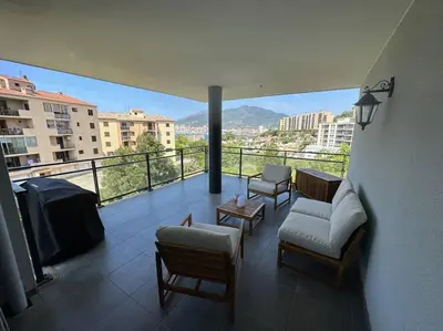 a balcony with a view of a city from a building at Magnifique T2 ajaccio in Ajaccio