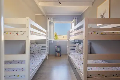 a room with three bunk beds with a window at Villa MonteCristo, clim, piscine privée, 300m. mer in Talasani