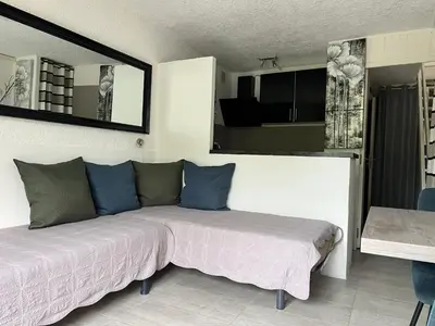 a bedroom with a bed with blue pillows on it at Résidence les pieds dans l'eau in Porto-Vecchio