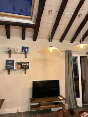 a living room with a flat screen tv on a wall at Appartement vue sur le port - Chez Carlu in Bonifacio