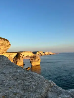 a view of the ocean from a rocky coast at Appartement vue sur le port - Chez Carlu in Bonifacio