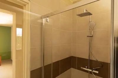 a shower with a glass door in a bathroom at Residence Mare e Sole in Taglio-Isolaccio