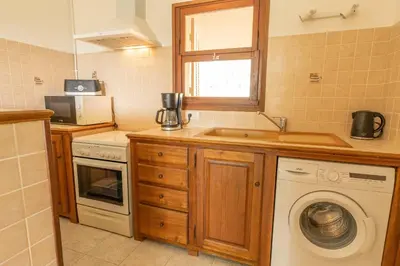 a kitchen with a washing machine and a sink at Residence Mare e Sole in Taglio-Isolaccio