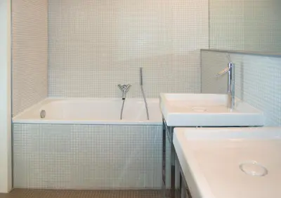 a bathroom with a bath tub and a sink at Villa Coucou Les Amis in Sainte-Lucie de Porto-Vecchio